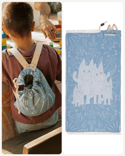 A light blue drawstring backpack with white line-art illustrations of three cartoon cats, shown both hanging on a child's back in a lifestyle setting and as a flat product image on a white background.