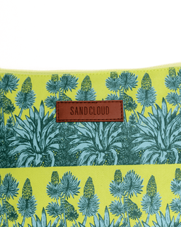 Product with a tropical plant pattern and 'Sandcloud' label on a yellow background