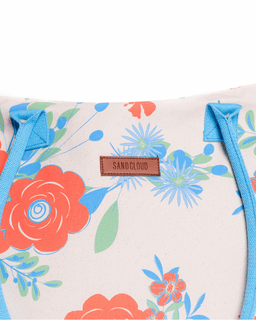 Floral-patterned bag with 'Sandcloud' brand label on a white background