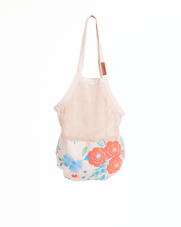 Floral-patterned bag with a beige top section on a white background