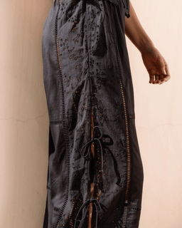 Dark blue dress with intricate patterns on a beige background