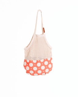 Tote bag with a white top section and polka dot bottom section on a white background