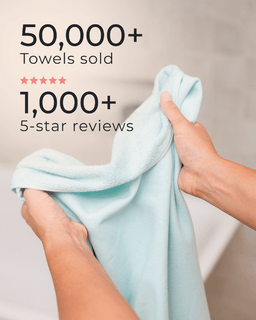 Light blue towel held by hands with text indicating sales and reviews on a beige background