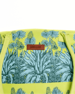 Product with agave pattern and 'Sand Cloud' label on a yellow background