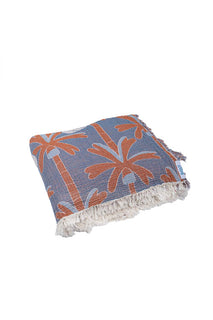 Folded up blanket with bluey and family design on a white background