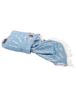 Blue fabric with white patterns and white tassels on a white background