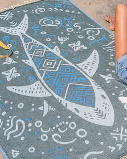 Towel with shark design on a beach