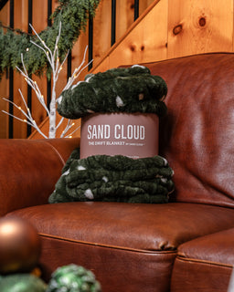 Drift Blanket sitting on the couch with a sleeve
