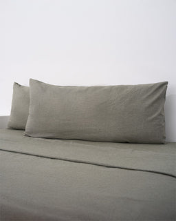 Moss bedding set with two pillows on a plain background