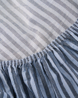 Close-up of a striped fabric with horizontal gray and white lines.