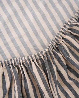 Close-up of a striped fabric with blue and beige horizontal lines.