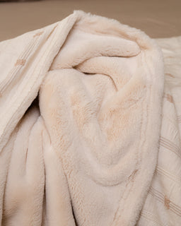 Close-up of a beige textured fabric with a soft texture.