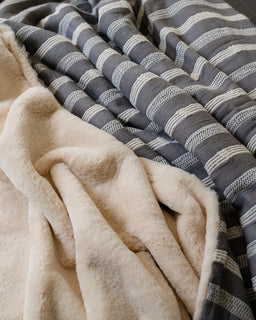 Close-up of beige fleece fabric and gray striped fabric