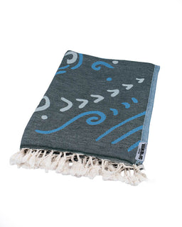 Gray towel with blue wave pattern and white tassels on a white background