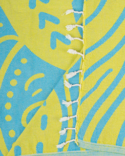 Close-up of a fabric with blue and yellow abstract patterns and white fringe.