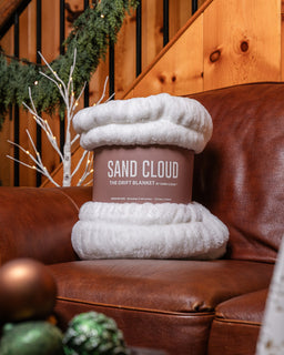Drift Blanket sitting on the couch with a sleeve