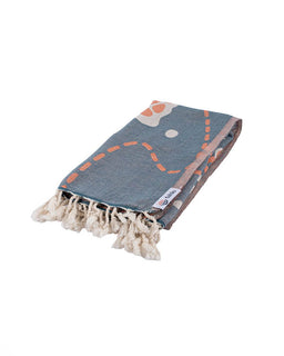 Blue towel with orange and white patterns on a white background