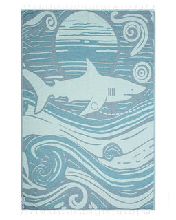 Shark-themed towel with wave patterns on a blue background