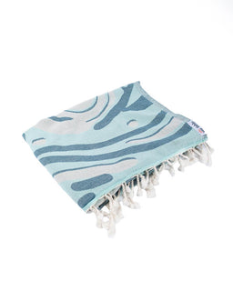 blue towel folded up on white background with twisted tassels