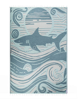 Shark-themed towel with wave patterns on a blue background