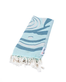folded blue towel on white background with twisted tassels