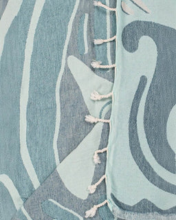 Close-up of a textured fabric with abstract patterns in blue and gray.