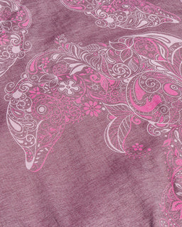 A close-up of a heathered mauve-purple fabric with a large pink and white dolphin paisley pattern across it.