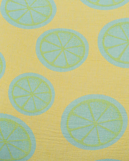 Pattern of light blue lime slices on a yellow background