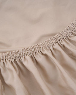Close-up of beige fabric with an elastic waistband