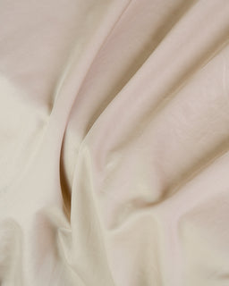 Close-up of beige fabric with folds