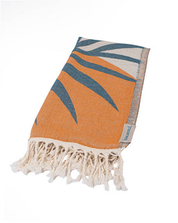 Towel with leaf pattern and fringes on a white background