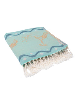 Light blue towel with white fringe and decorative patterns on a white background