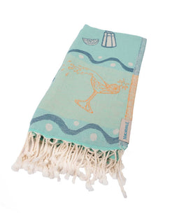 Turquoise towel with white fringe and decorative patterns on a white background