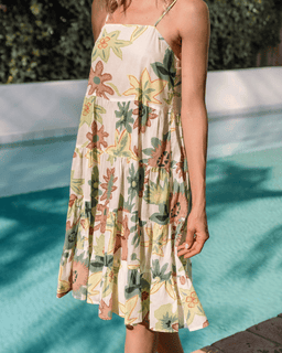 Person wearing a floral dress by a pool