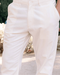 Close-up of white pants with a blurred natural background