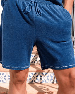 Blue shorts with drawstring on a blurred outdoor background