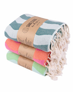 Stack of colorful beach towels with a brand label on a white background
