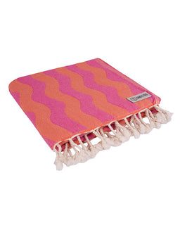 Pink and orange striped towel with tassels on a white background