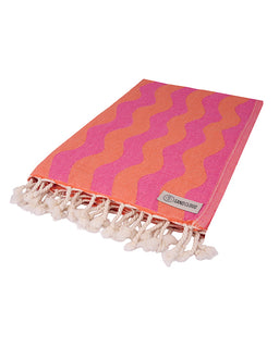 Pink and orange patterned towel with tassels on a white background