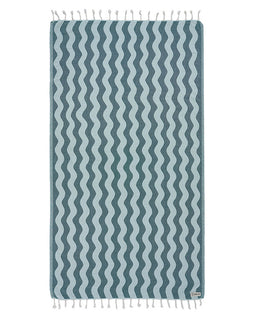 Blue and white wavy patterned towel with tassels on a white background