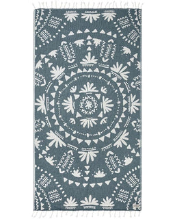 Blue and white patterned towel with tassels on a white background