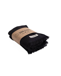 folded black hand towels with brown packaging on a white background