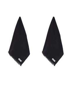 Two black fringed hand towels laid flat on a white background, each with a small white rectangular brand tag near the bottom edge.