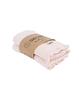 A pair of folded pale pink cotton towels wrapped in a brown kraft paper band .