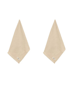 Two light beige cotton hand towels with fringed edges and small white brand tags, displayed side-by-side on a solid white background.