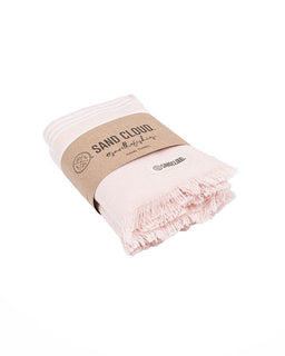 folded pink bath towels with white stripes and brown packgaing on a white bakcground