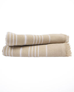 A folded beige cotton towel with white stripes and fringed edges, stacked on a white background.