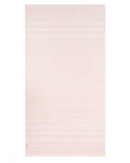 A rectangular beach towel in a pale blush pink color with thin, horizontal white stripes and fringed edges, shown flat against a white background.