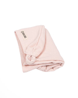 Folded pink hair towel on a white background