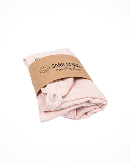 Folded pink hair towel on a white background